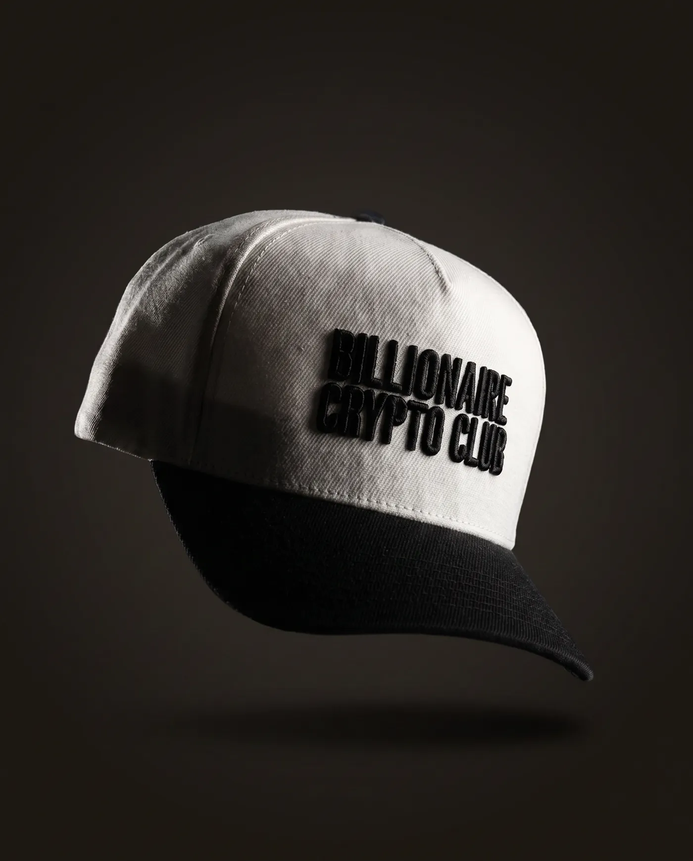 The Genesis, cream five-panel cap with black brim and black 3D embroidery